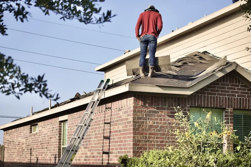 Professional roofer working on a residential roof in East Arlington